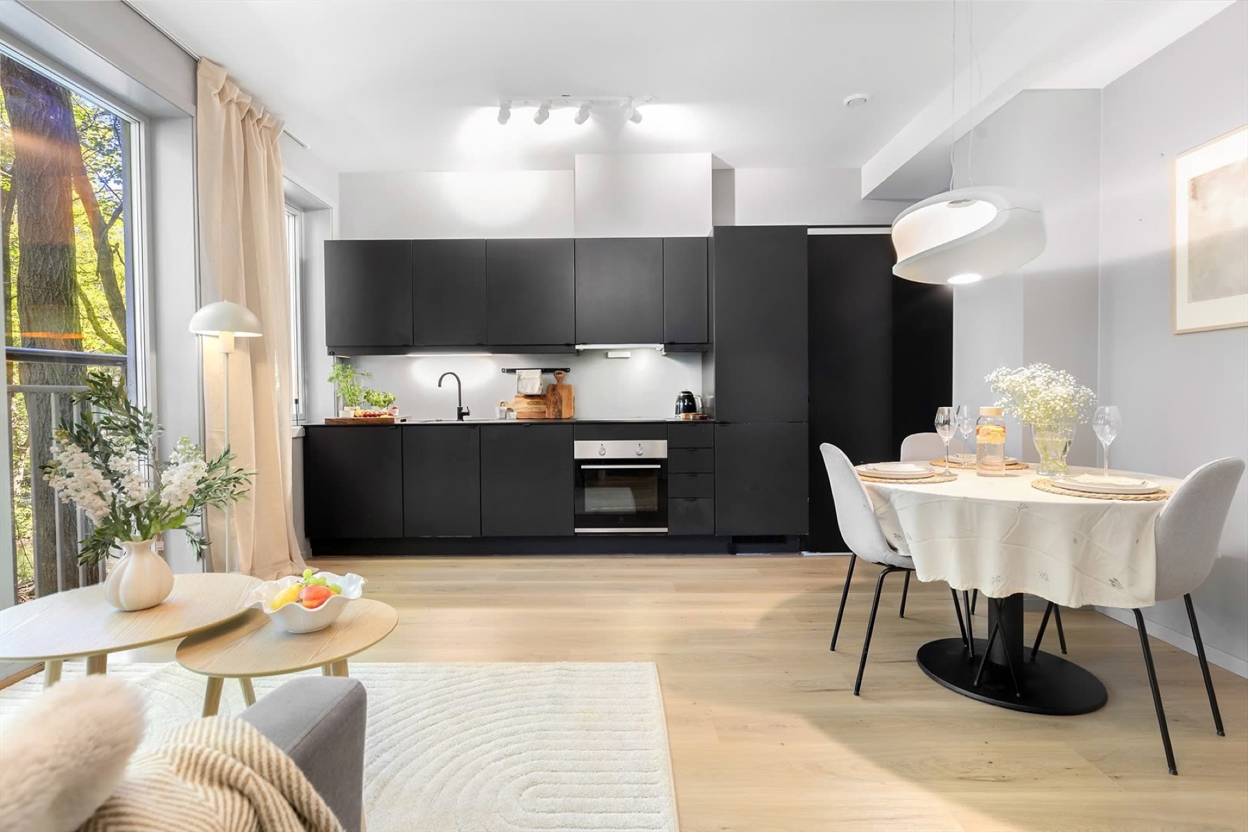 Open kitchen with dark cabinets and a dining area