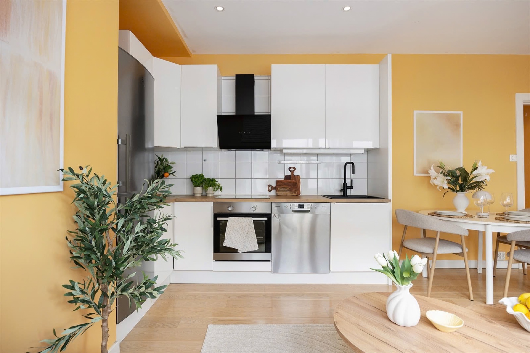 Open kitchen and dining area with yellow walls