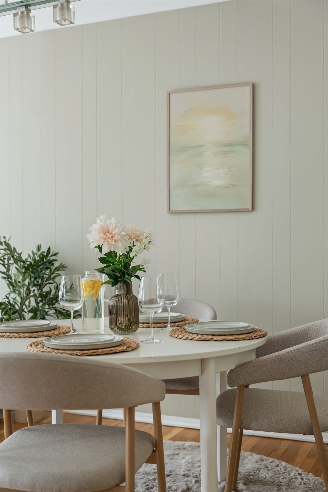 Dining area with flowers and soft green tones